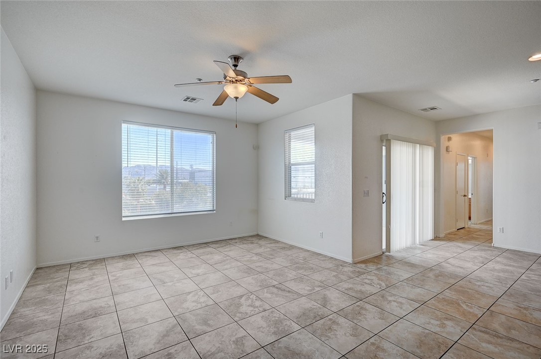 4437 Dover Straight Street, Unit 208 Las Vegas, NV 89115 - Photo 1 of 33 Spare room with light tile patterned floors and a ceiling fan