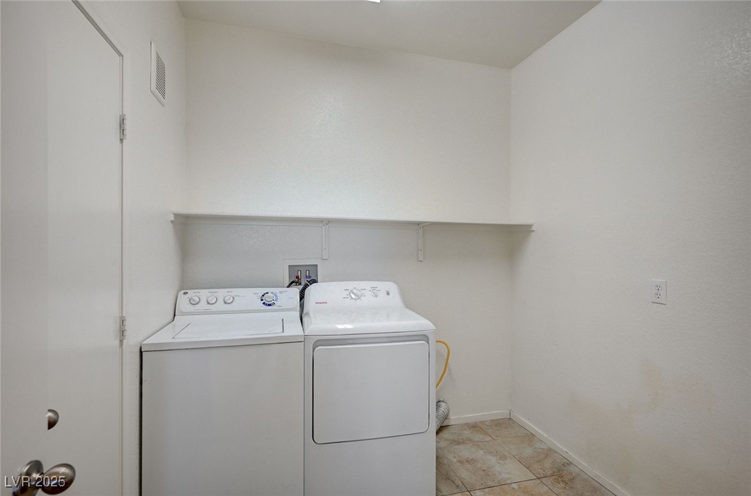 4437 Dover Straight Street, Unit 208 Las Vegas, NV 89115 - Photo 13 of 33 Washroom with light tile patterned floors and washer and clothes dryer