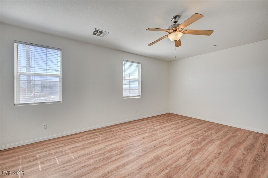 4437 Dover Straight Street, Unit 208 Las Vegas, NV 89115 - Photo 14 of 33 Unfurnished room with light wood finished floors and ceiling fan