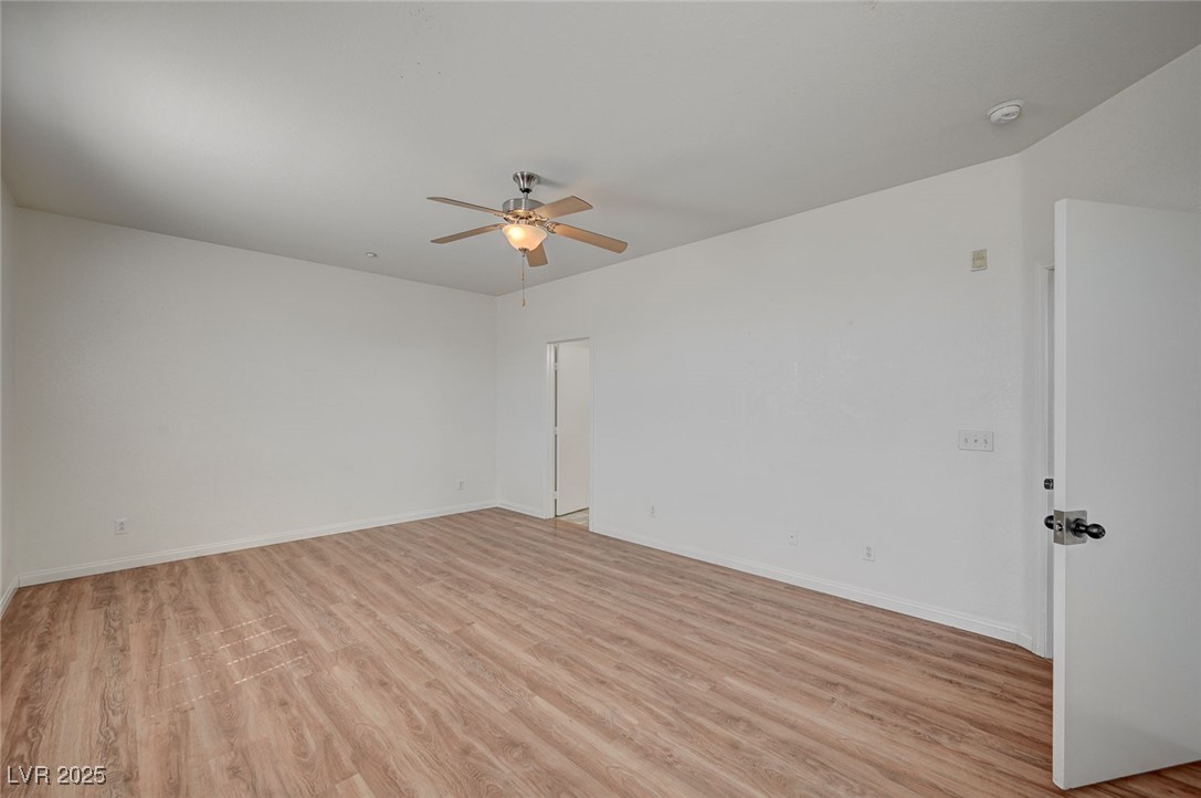 4437 Dover Straight Street, Unit 208 Las Vegas, NV 89115 - Photo 15 of 33 Unfurnished room featuring light wood-style floors and ceiling fan
