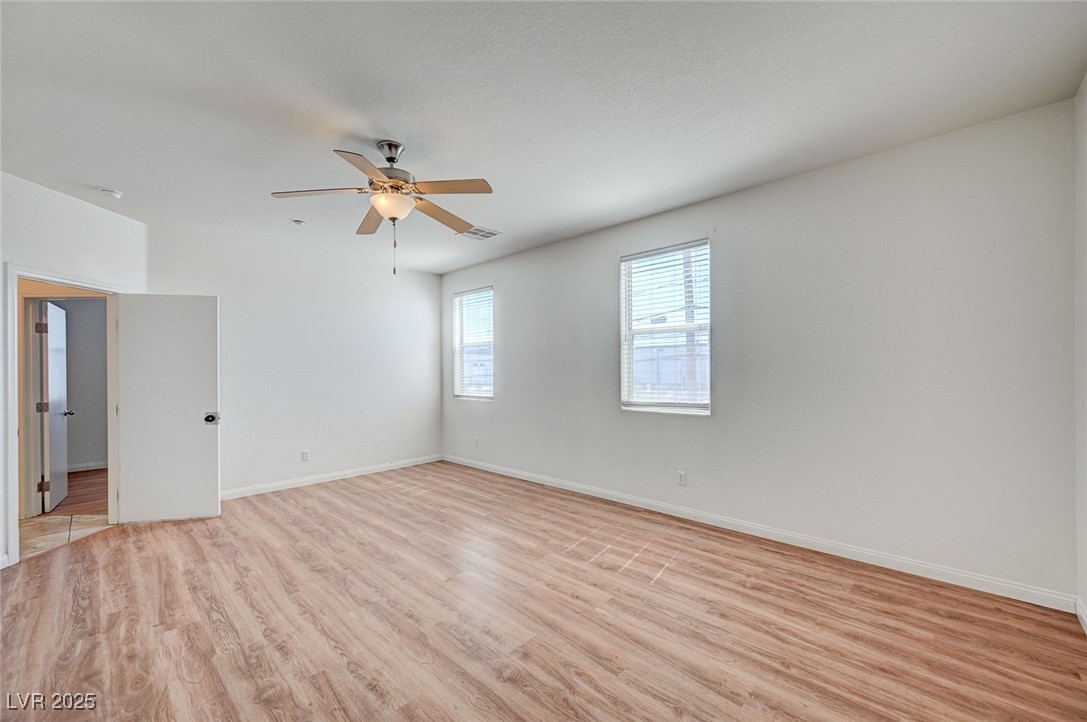4437 Dover Straight Street, Unit 208 Las Vegas, NV 89115 - Photo 17 of 33 Empty room featuring light wood-style flooring and a ceiling fan