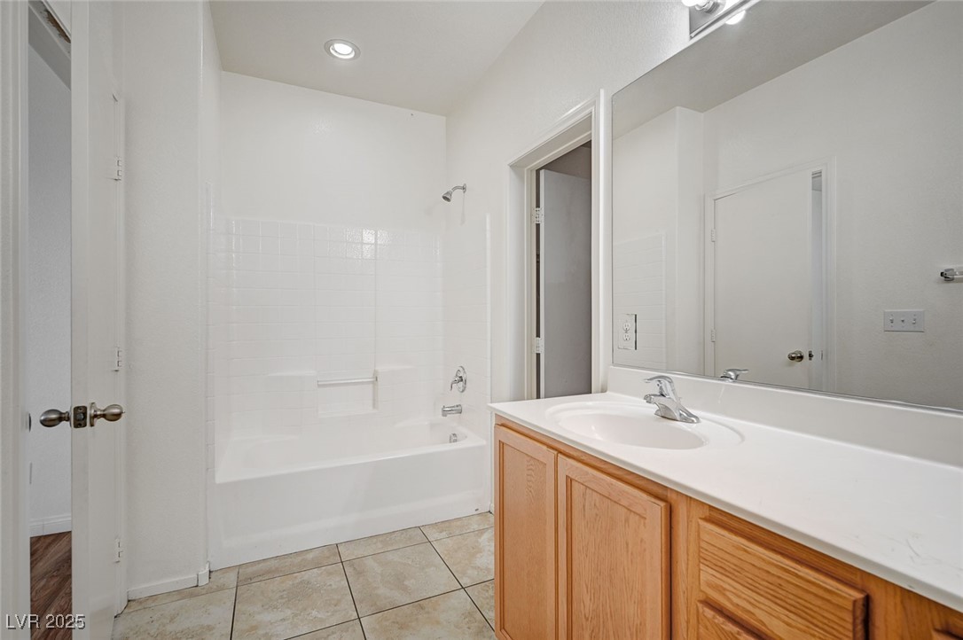 4437 Dover Straight Street, Unit 208 Las Vegas, NV 89115 - Photo 19 of 33 Full bath with shower / tub combination, vanity, and light tile patterned floors
