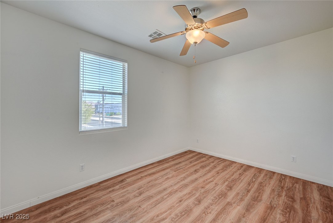 4437 Dover Straight Street, Unit 208 Las Vegas, NV 89115 - Photo 21 of 33 Spare room with light wood-type flooring and ceiling fan