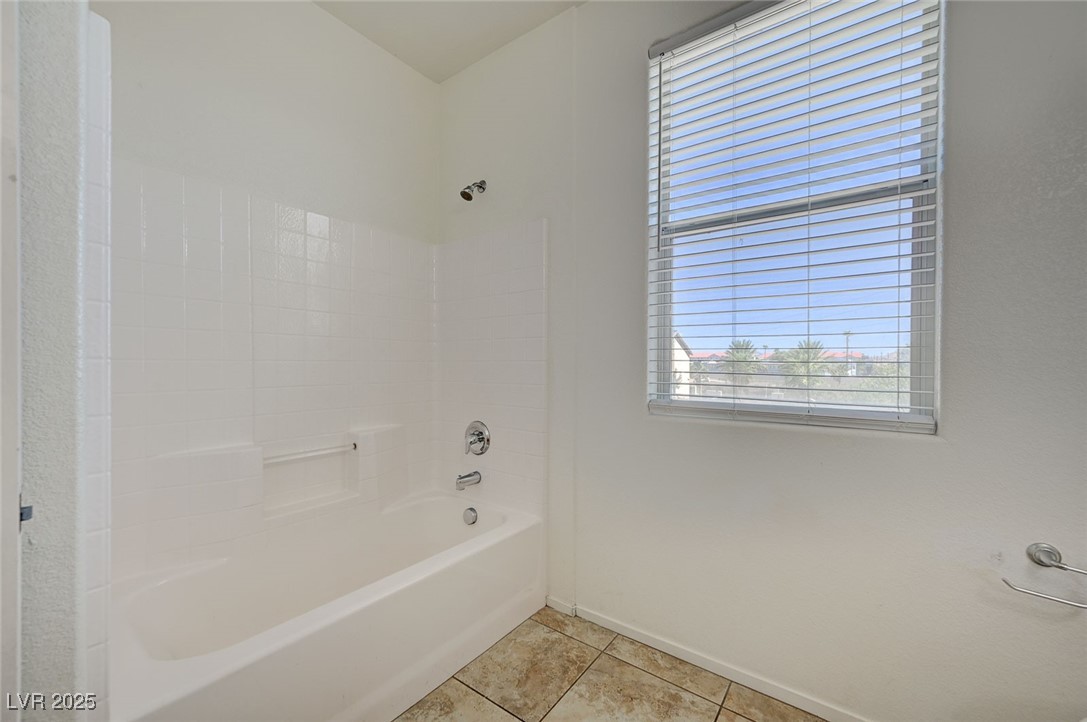 4437 Dover Straight Street, Unit 208 Las Vegas, NV 89115 - Photo 27 of 33 Bathroom with healthy amount of natural light, bathing tub / shower combination, and light tile patterned floors