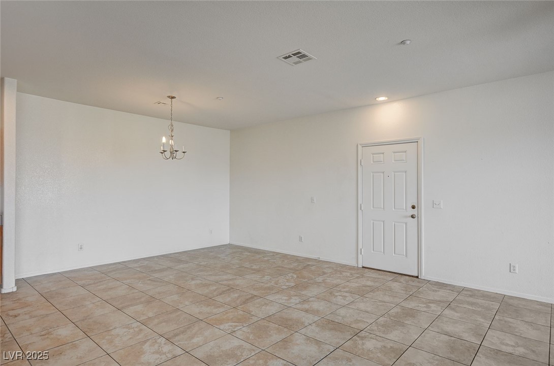 4437 Dover Straight Street, Unit 208 Las Vegas, NV 89115 - Photo 4 of 33 Empty room with a chandelier, light tile patterned floors, and recessed lighting