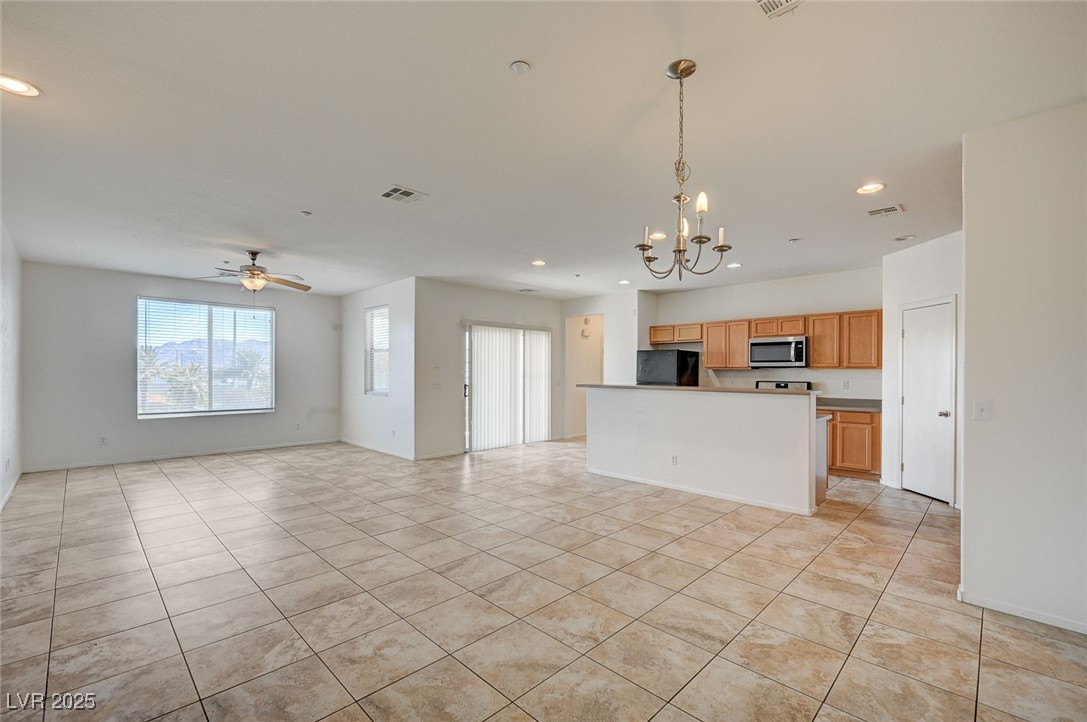 4437 Dover Straight Street, Unit 208 Las Vegas, NV 89115 - Photo 5 of 33 Unfurnished living room with recessed lighting, a chandelier, ceiling fan, and light tile patterned floors
