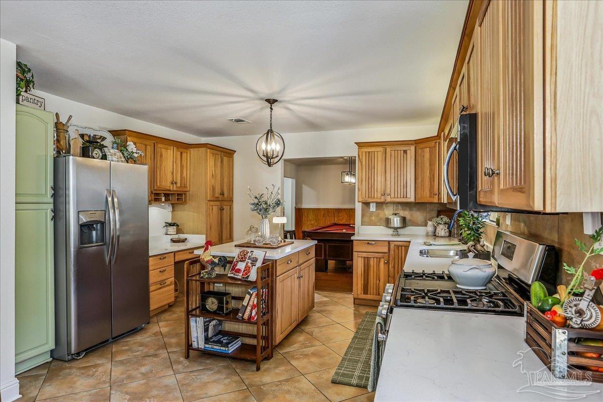 9481 Bridlewood Road Pensacola, FL 32526 - Photo 13 of 45 a kitchen with stainless steel appliances a stove a refrigerator and furniture