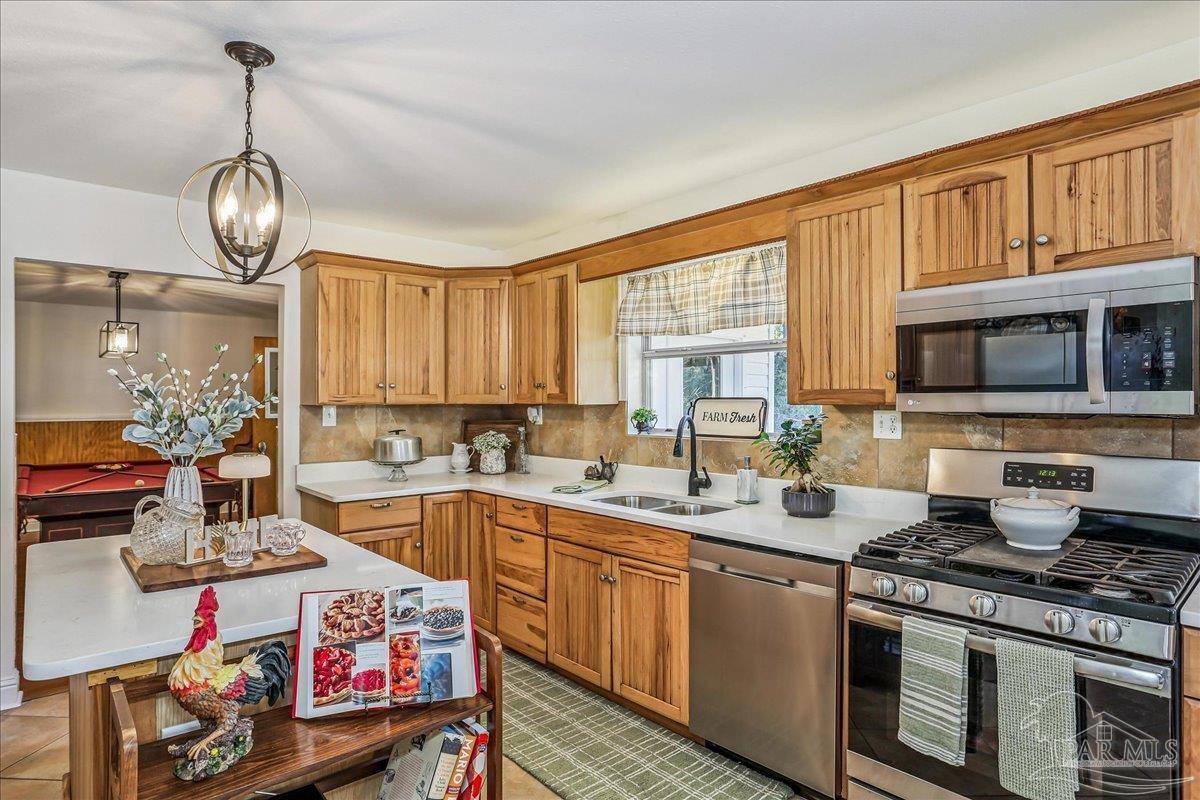 9481 Bridlewood Road Pensacola, FL 32526 - Photo 15 of 45 a open kitchen with stainless steel appliances granite countertop a stove and a sink