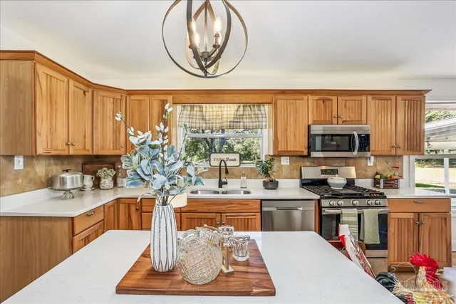 a kitchen with a stove a refrigerator and a sink