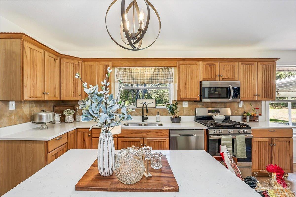 9481 Bridlewood Road Pensacola, FL 32526 - Photo 16 of 45 a kitchen with a stove a refrigerator and a sink