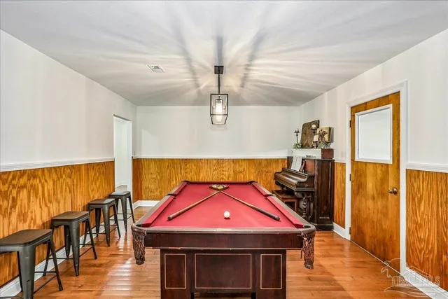 a room with furniture and pool table