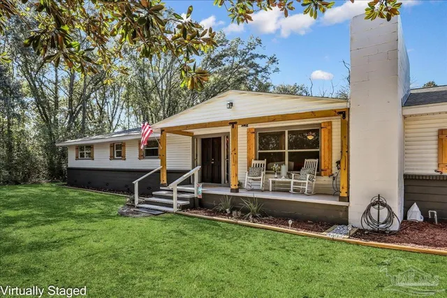a front view of house with a garden and patio