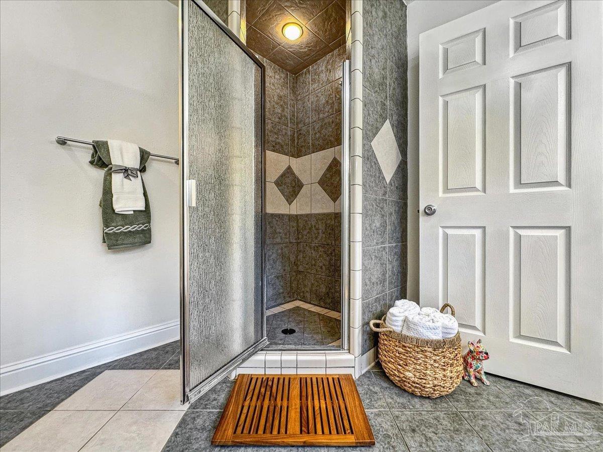 9481 Bridlewood Road Pensacola, FL 32526 - Photo 26 of 45 a room that has a bed and a chandelier