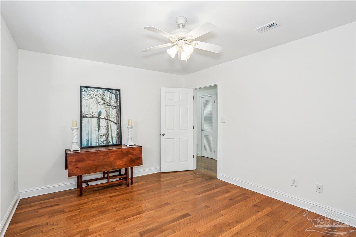 9481 Bridlewood Road Pensacola, FL 32526 - Photo 29 of 45 a living room with furniture and a chandelier