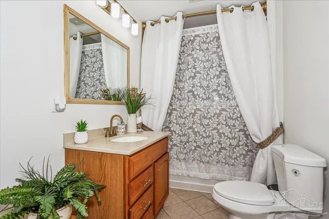 a bathroom with a sink a toilet and shower curtain