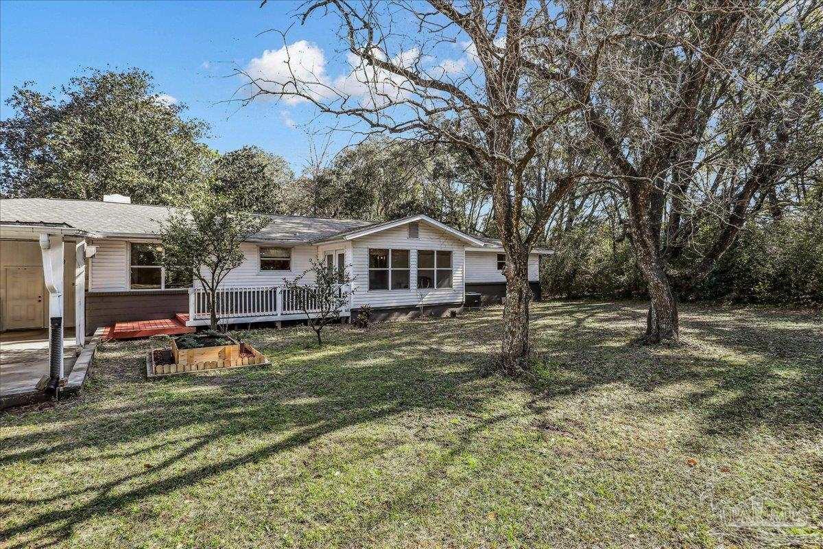 9481 Bridlewood Road Pensacola, FL 32526 - Photo 35 of 45 a backyard of a house with table and chairs