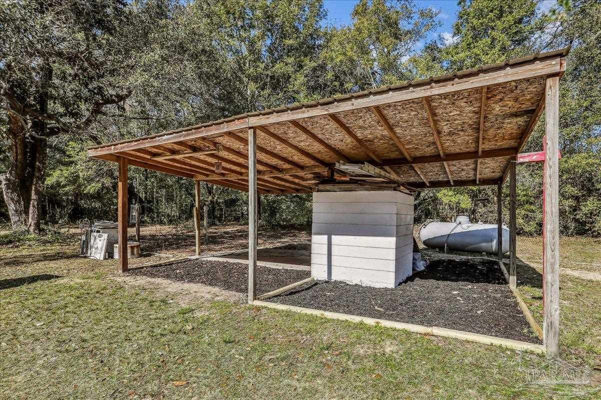 9481 Bridlewood Road Pensacola, FL 32526 - Photo 37 of 45 a wooden bench sitting in front of a building