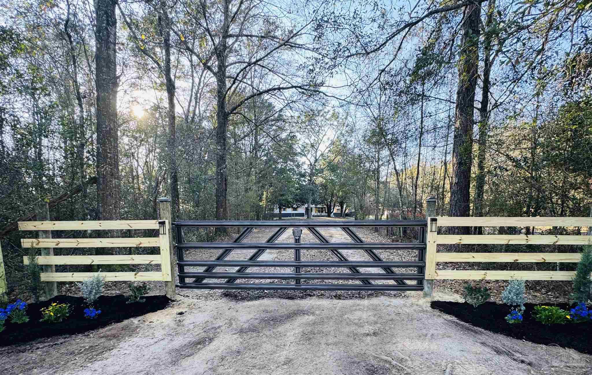 9481 Bridlewood Road Pensacola, FL 32526 - Photo 44 of 45 a view of a yard with a bench