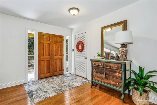 a view of an entryway with wooden floor