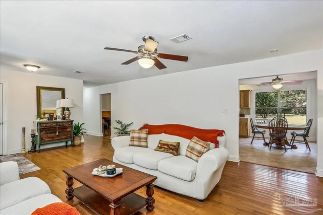 a living room with furniture a rug and a table