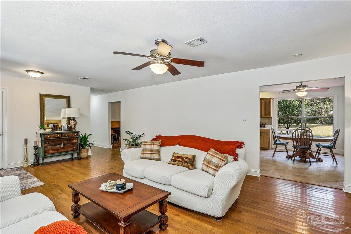 9481 Bridlewood Road Pensacola, FL 32526 - Photo 8 of 45 a living room with furniture a rug and a table