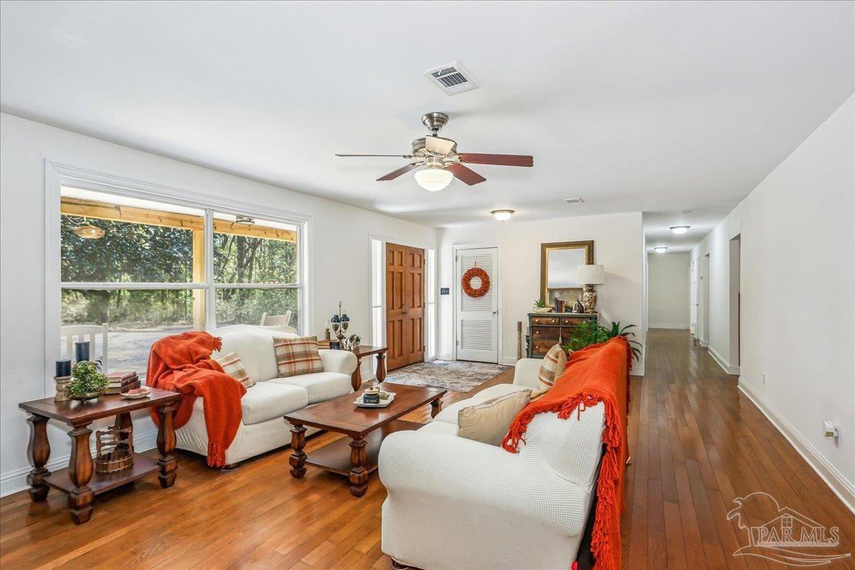 9481 Bridlewood Road Pensacola, FL 32526 - Photo 9 of 45 a living room with furniture and a large window