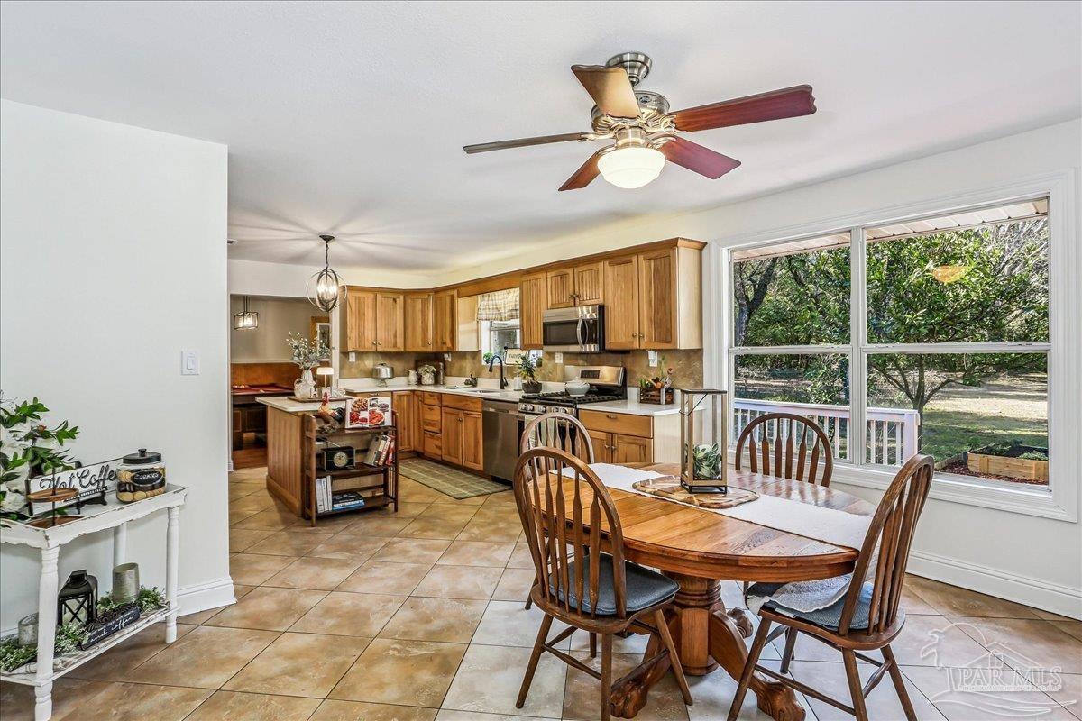 9481 Bridlewood Road Pensacola, FL 32526 - Photo 10 of 45 a view of a dining room with furniture window and outside view