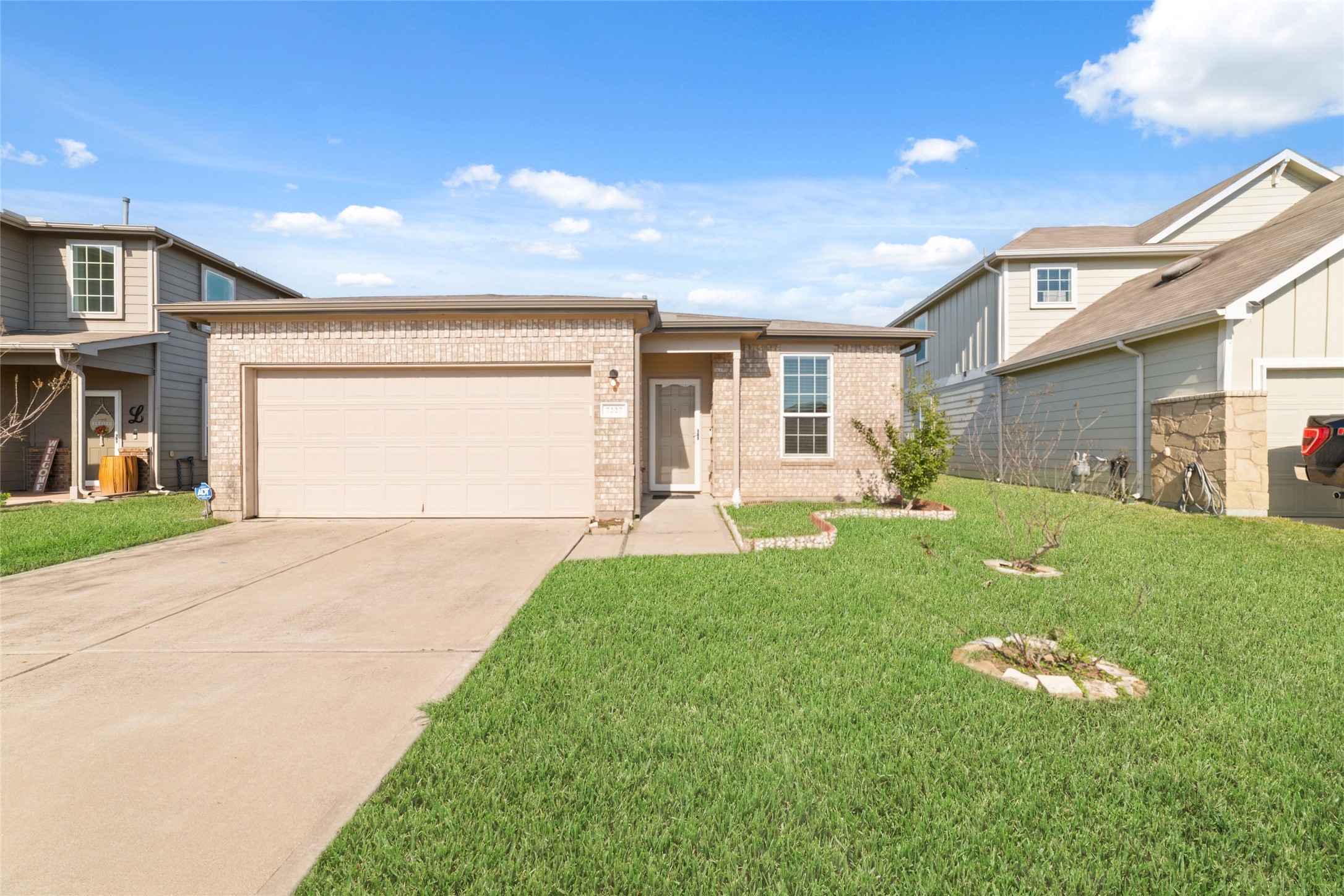 a front view of a house with a garden and plants