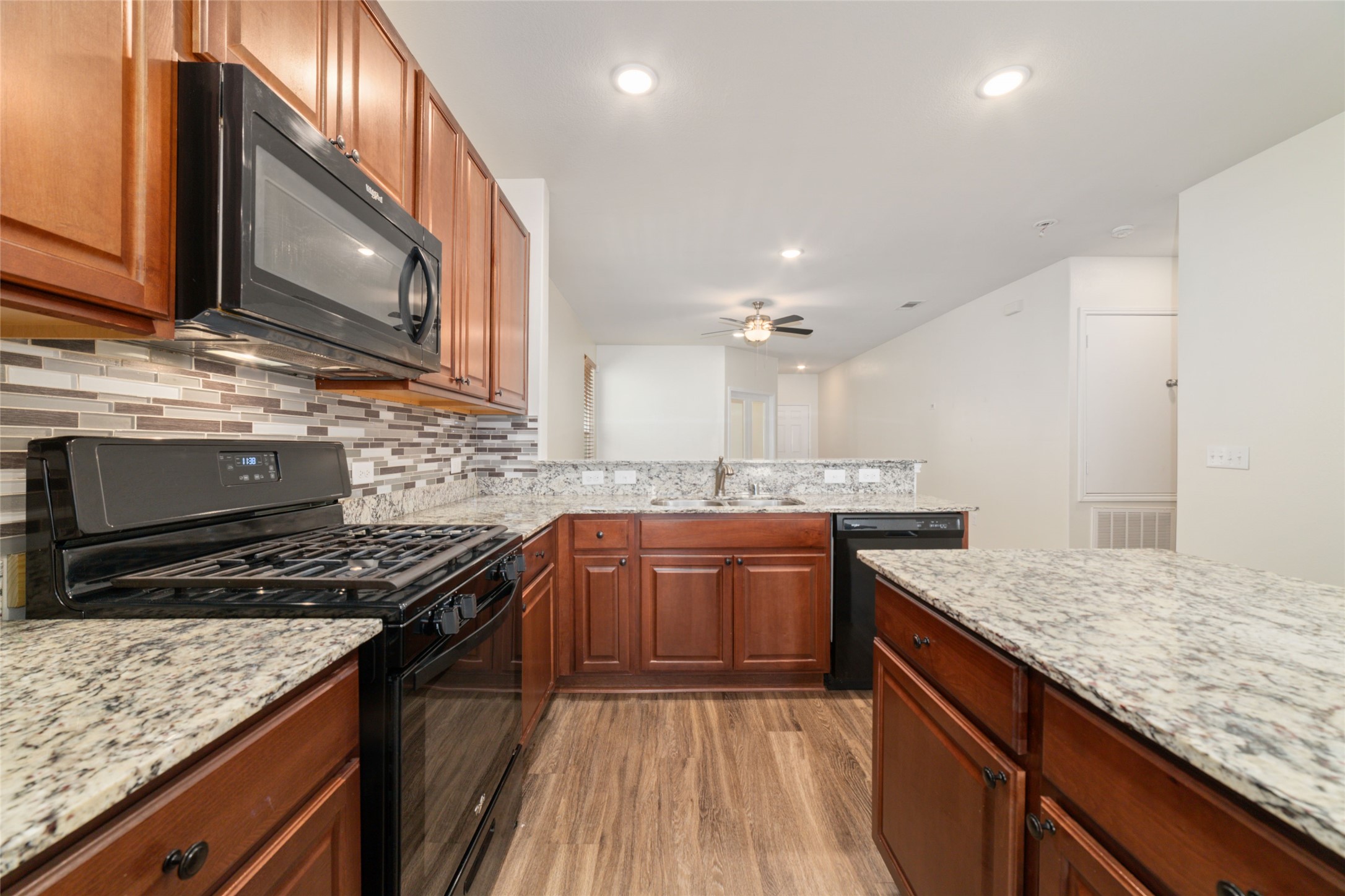 7227 Hobby Wind Ridge Drive Houston, TX 77075 - Photo 15 of 25 a kitchen with stainless steel appliances granite countertop a sink stove and oven