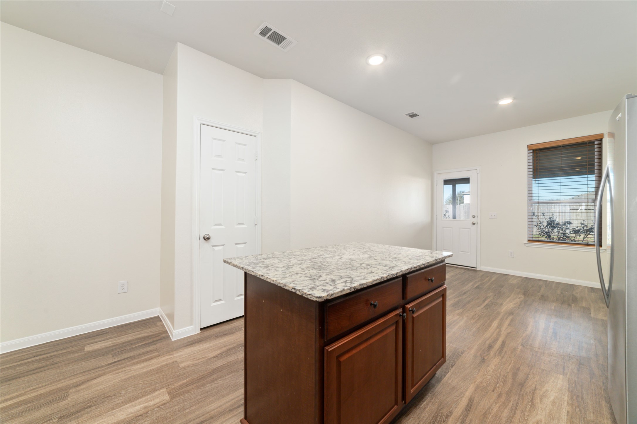 7227 Hobby Wind Ridge Drive Houston, TX 77075 - Photo 16 of 25 an empty room with wooden floor and window
