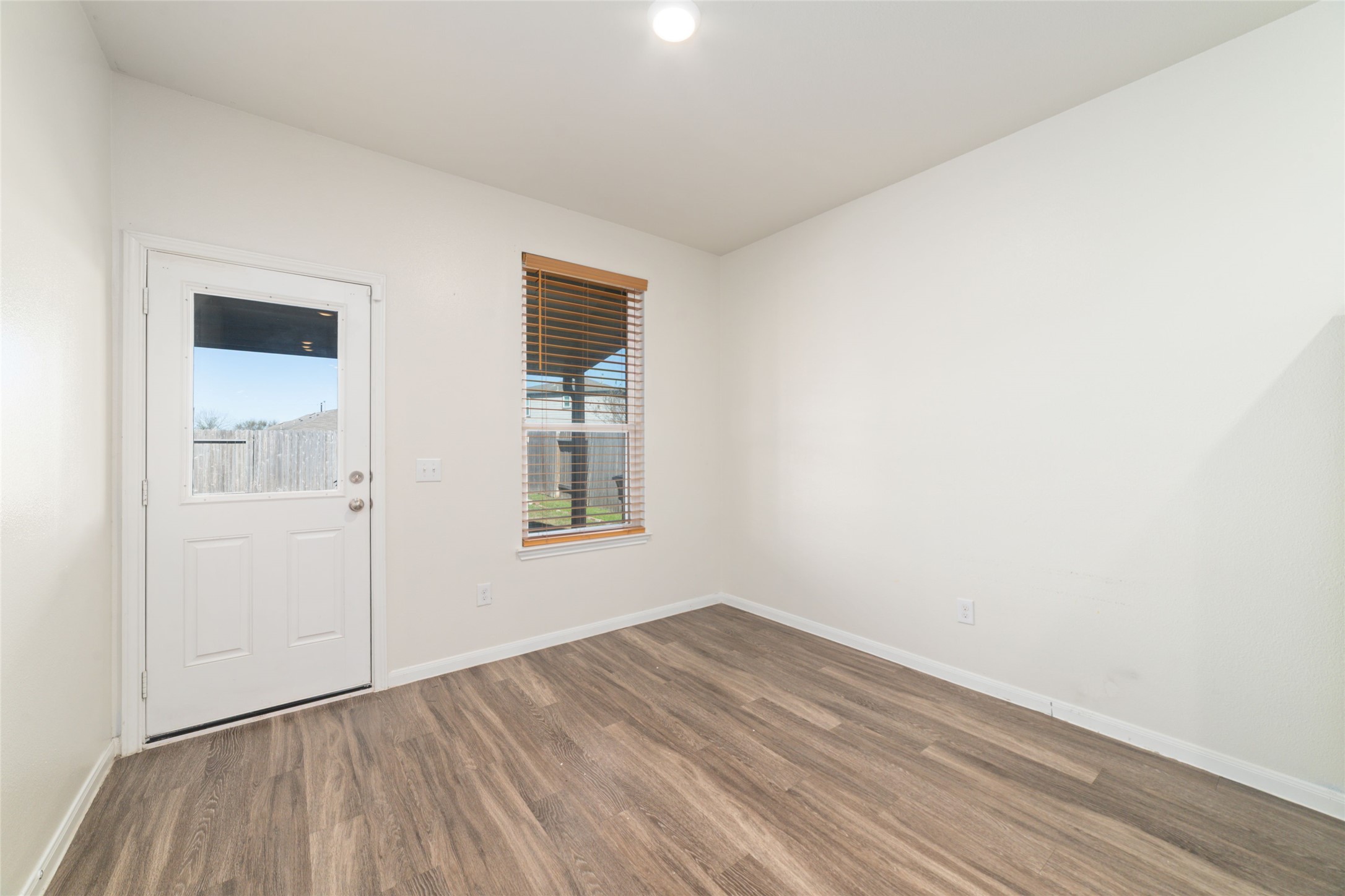 7227 Hobby Wind Ridge Drive Houston, TX 77075 - Photo 17 of 25 a view of empty room with wooden floor and fan
