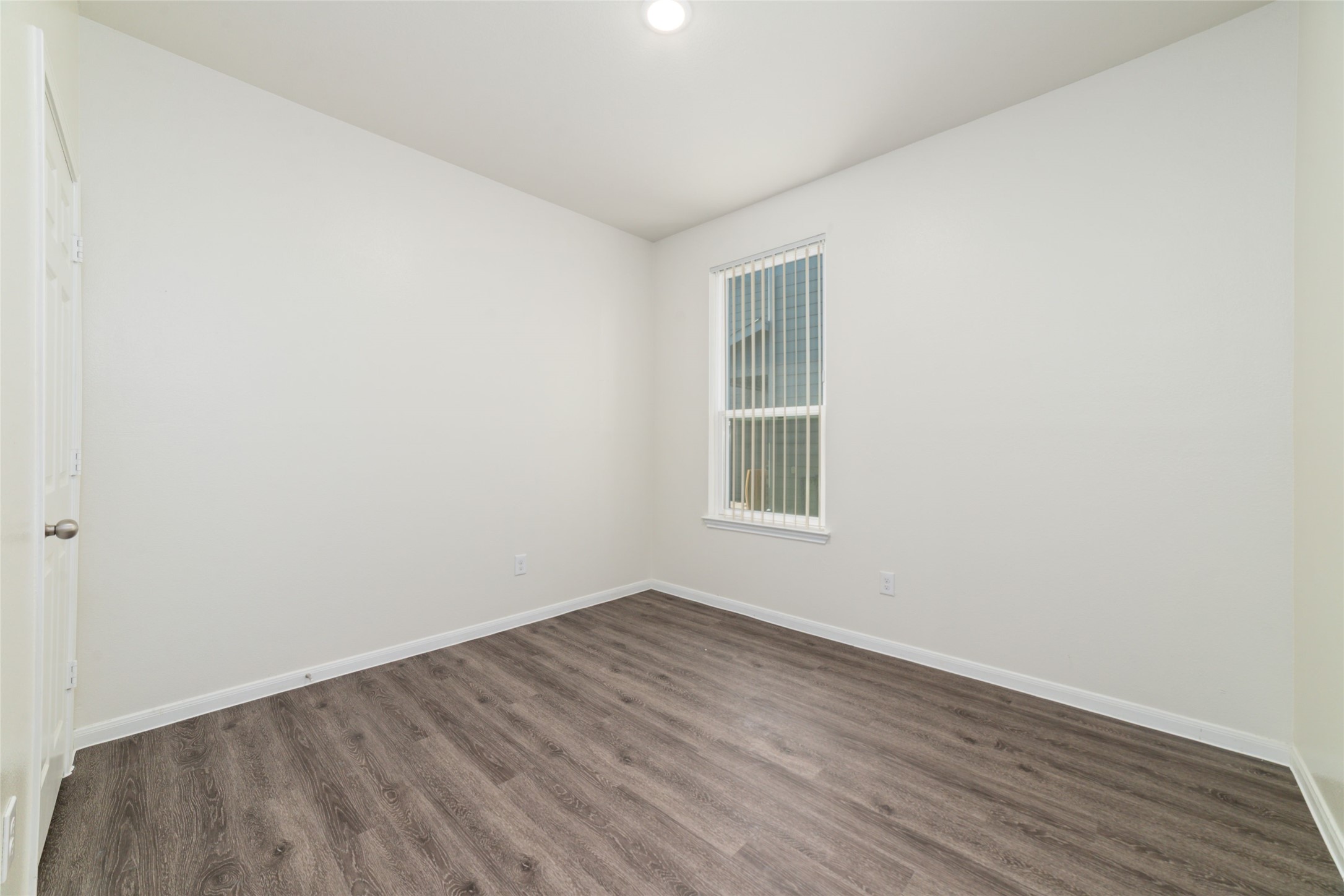 7227 Hobby Wind Ridge Drive Houston, TX 77075 - Photo 19 of 25 an empty room with wooden floor and windows