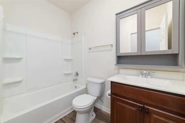 a bathroom with a sink toilet vanity and bathtub