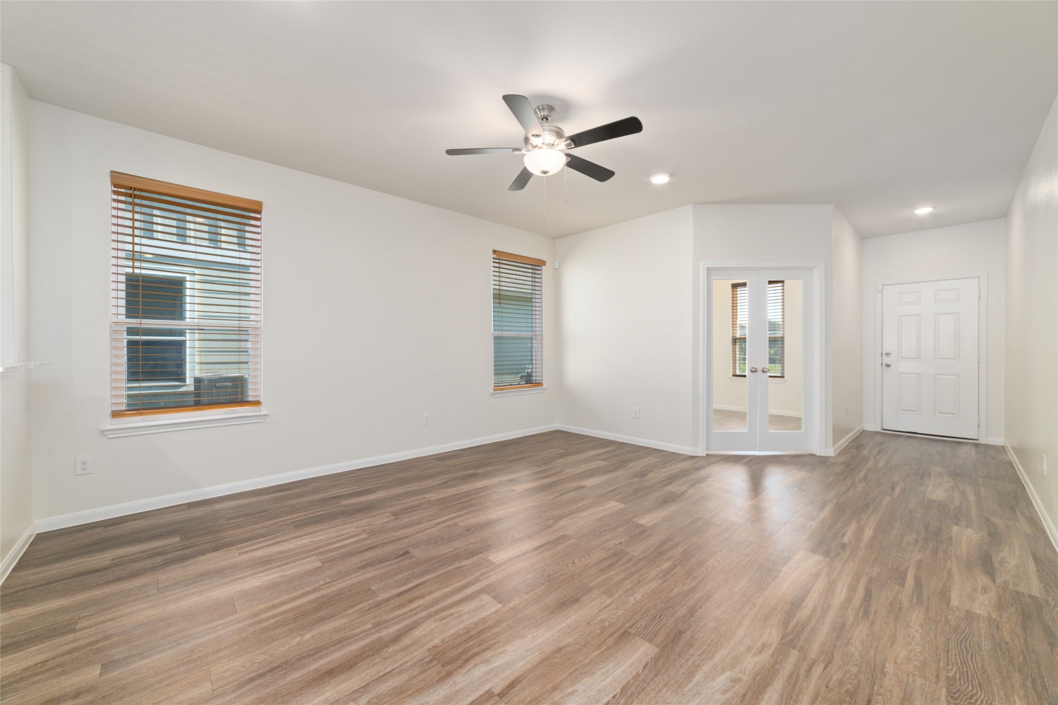 7227 Hobby Wind Ridge Drive Houston, TX 77075 - Photo 9 of 25 a view of empty room with wooden floor and fan