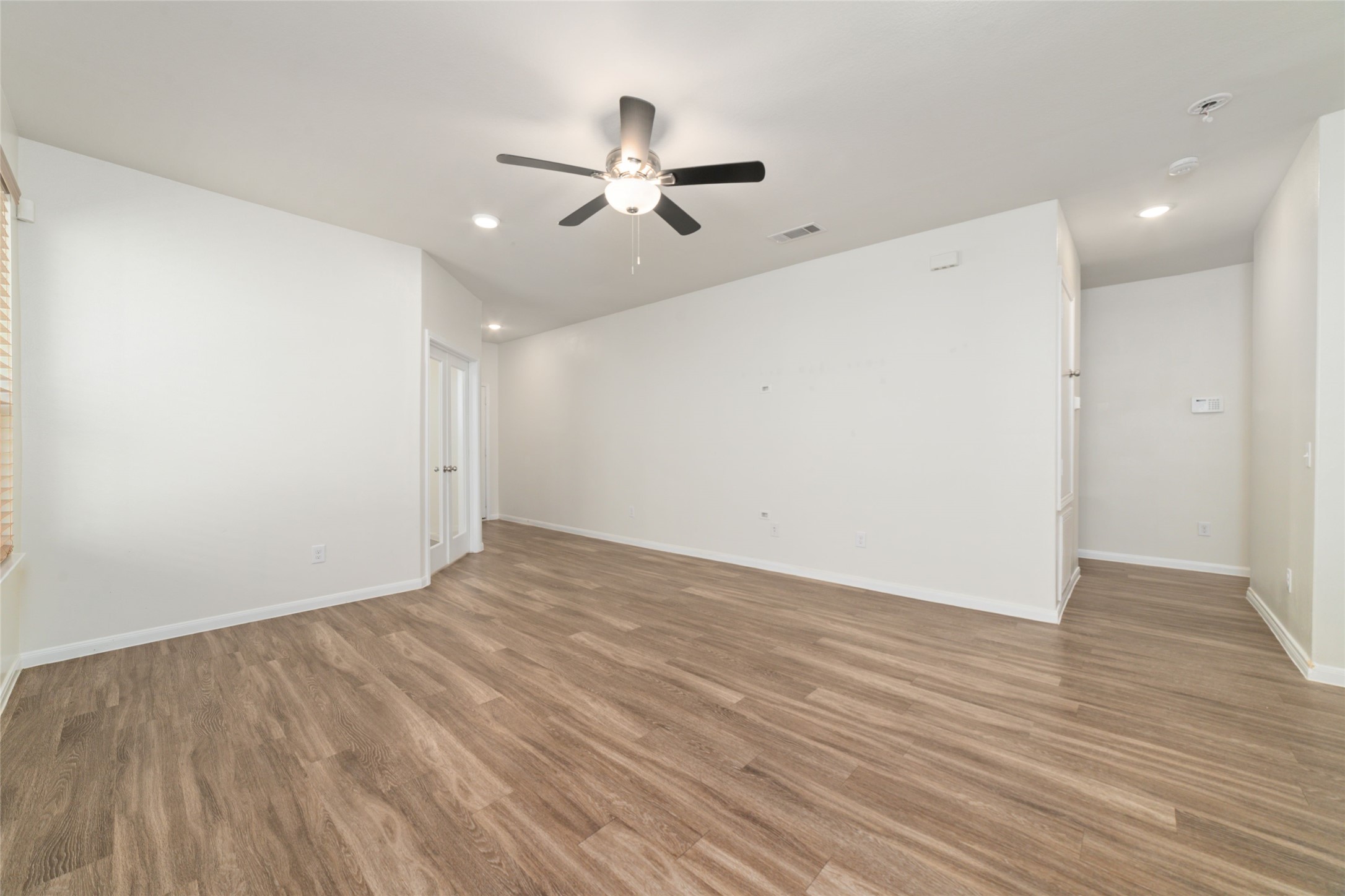 7227 Hobby Wind Ridge Drive Houston, TX 77075 - Photo 10 of 25 a view of an empty room with wooden floor