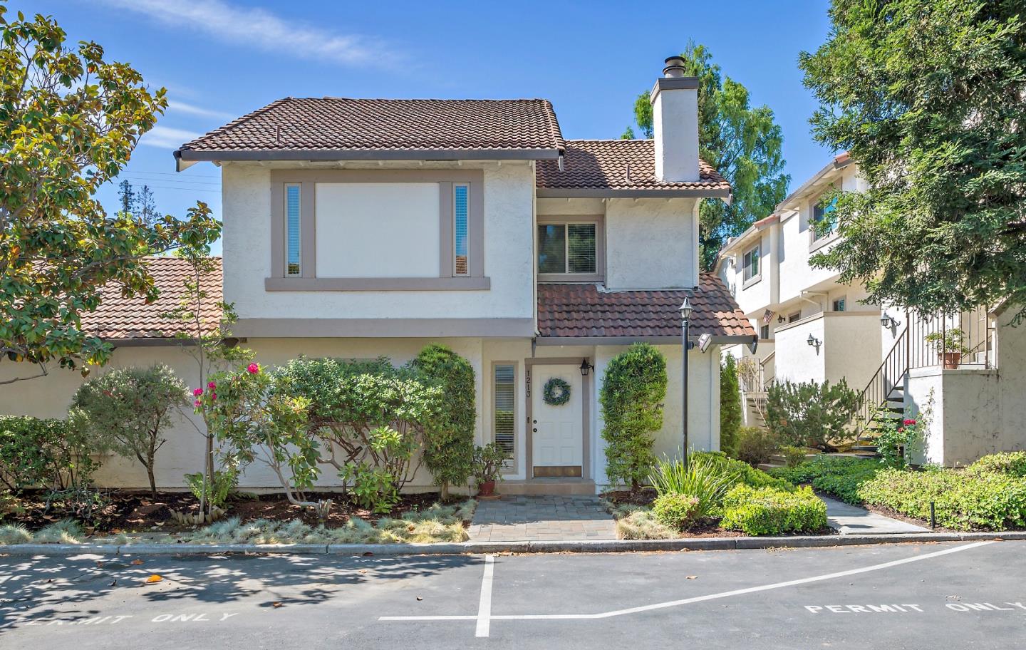 a front view of a house with a yard garage and outdoor seating