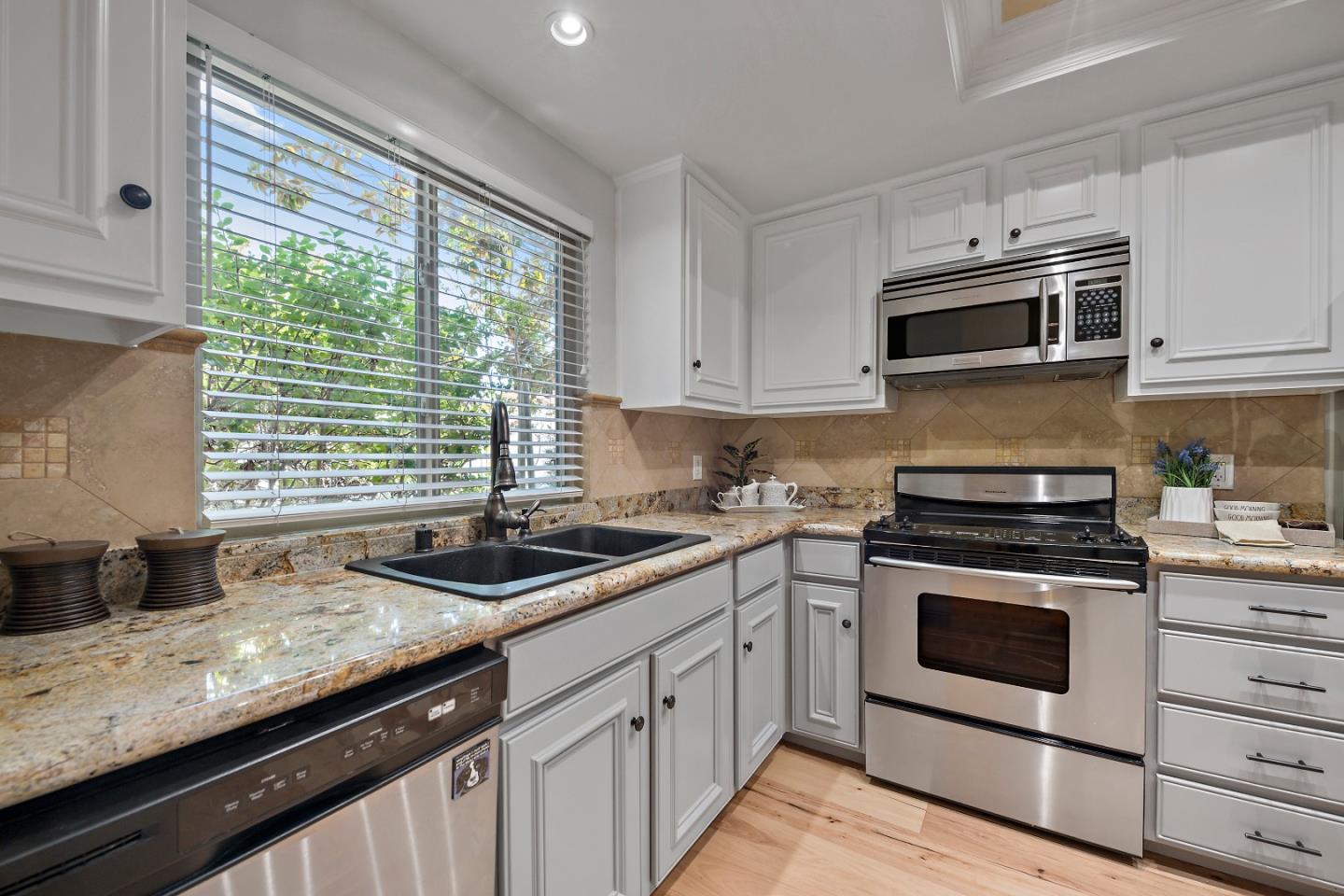 1213 Capri Drive Campbell, CA 95008 - Photo 10 of 27 a kitchen with stainless steel appliances granite countertop white cabinets sink and a stove top oven