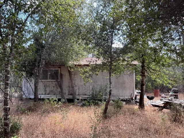 a backyard of a house with a table and chairs