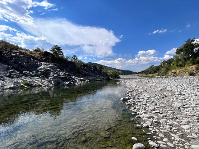 a view of a dry yard with mountains in the background