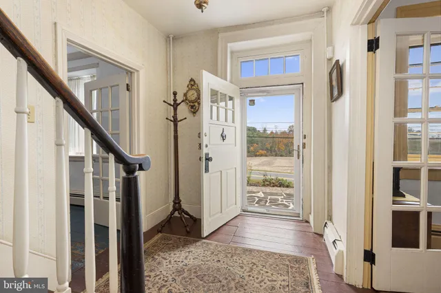 a kitchen with stainless steel appliances granite countertop a sink a stove a refrigerator cabinets and a window