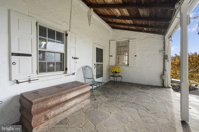 a spacious bedroom with a bed a table and windows