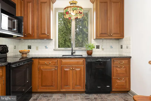 a kitchen with stainless steel appliances granite countertop a stove and a sink