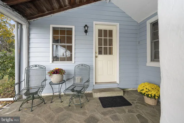 a living room with furniture and paintings on the wall