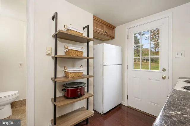 a backyard of a house with table and chairs