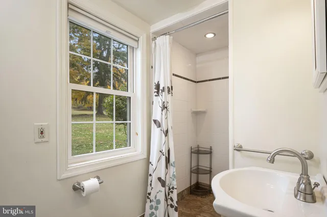 a living room with furniture a flat screen tv and wall paintings