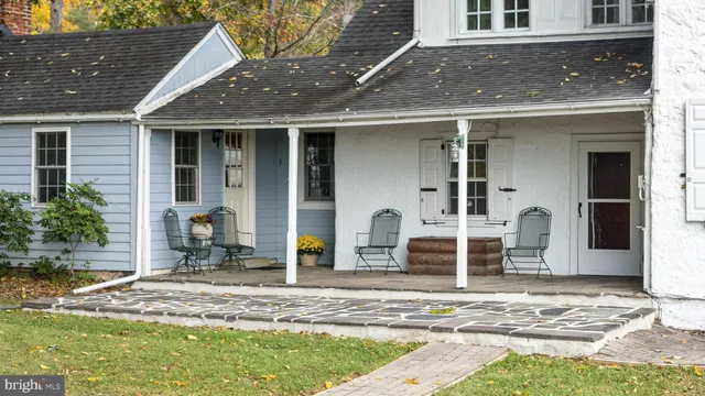 a backyard of a house with yard and outdoor seating