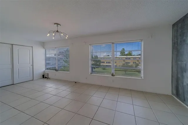 a view of a kitchen with refrigerator and microwave