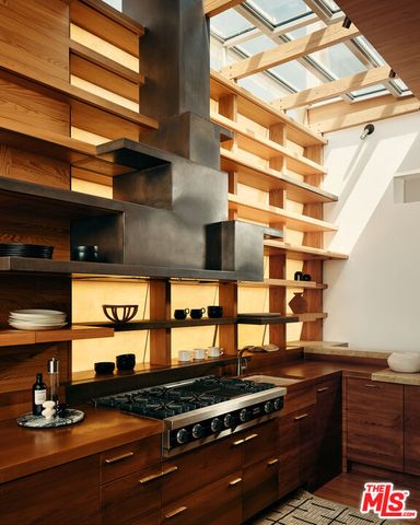 a kitchen with stainless steel appliances granite countertop a stove and a sink