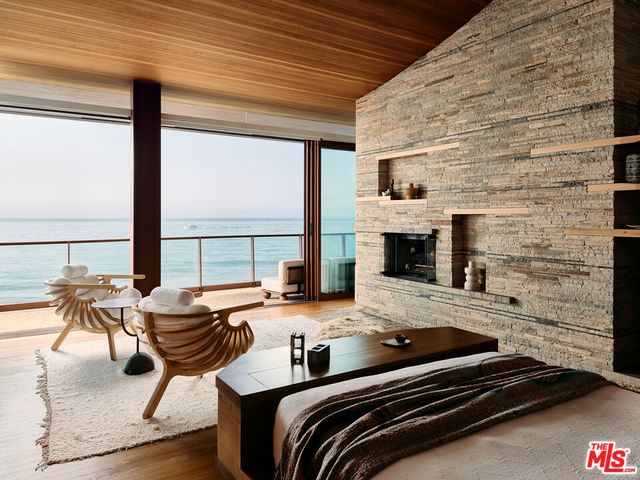 a bedroom with furniture and a fireplace