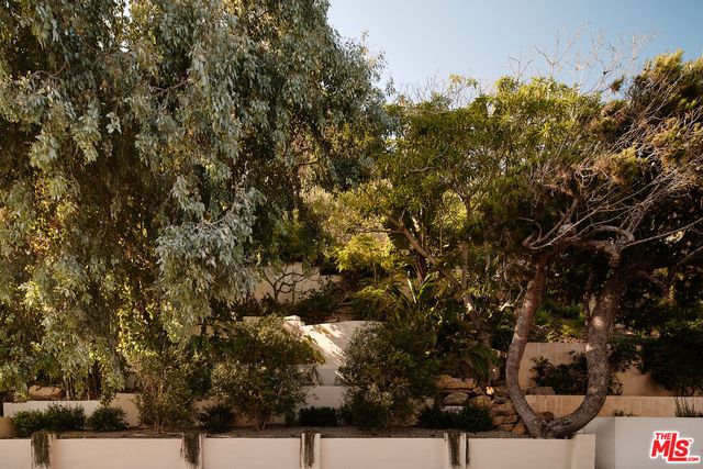 a living room with furniture a rug and a dining table